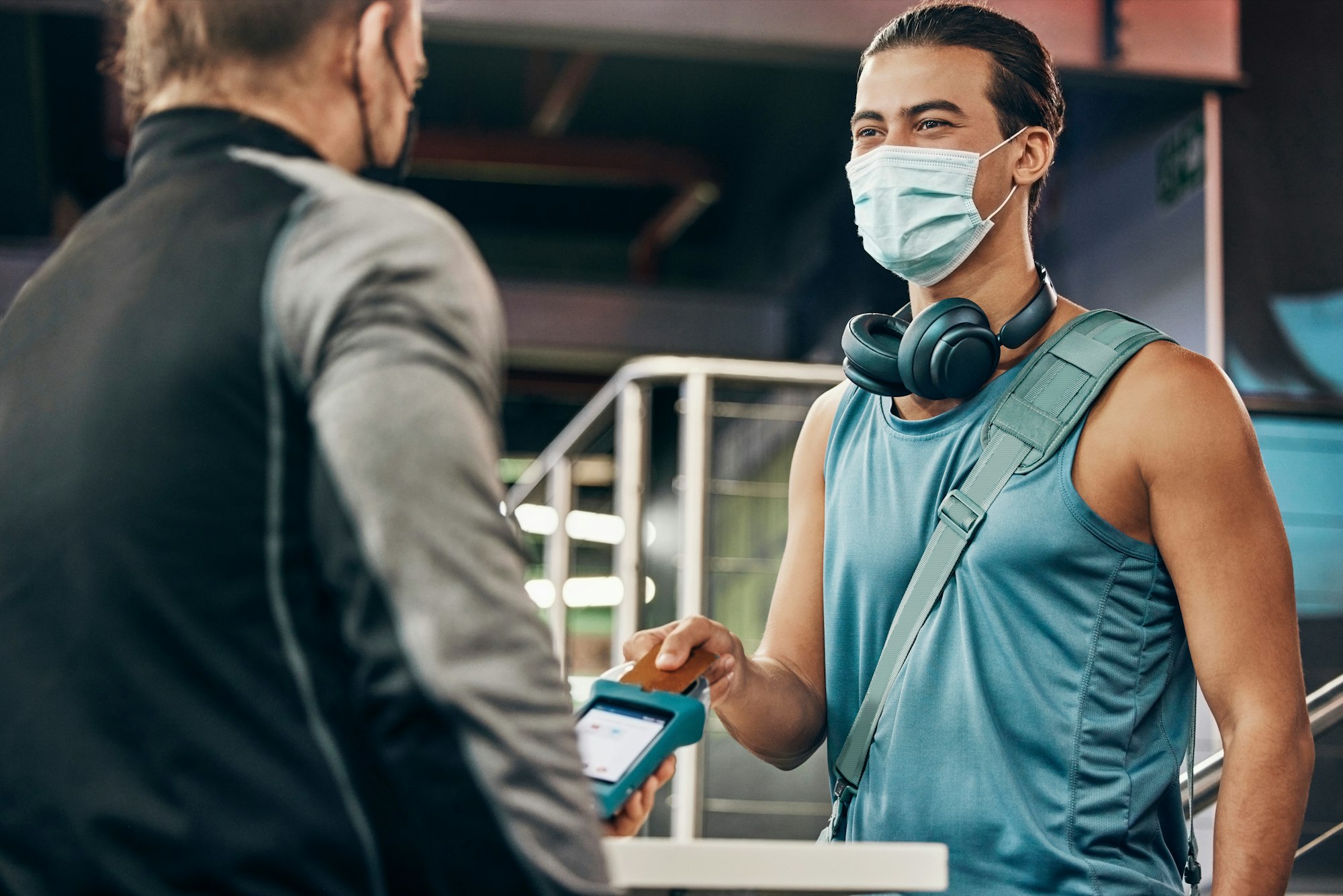 Covid, mask or credit card, payment and gym membership with digital machine, employee and fitness m